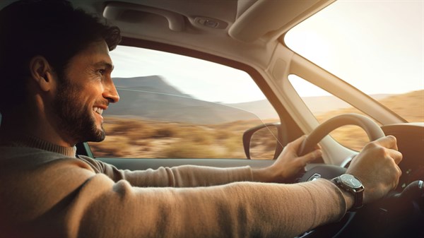 A man is smiling while driving