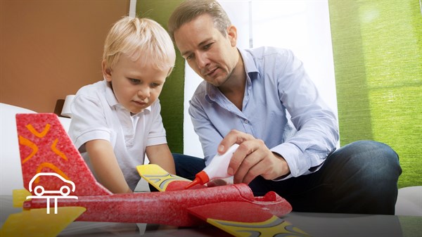 A man fixing his son's toy